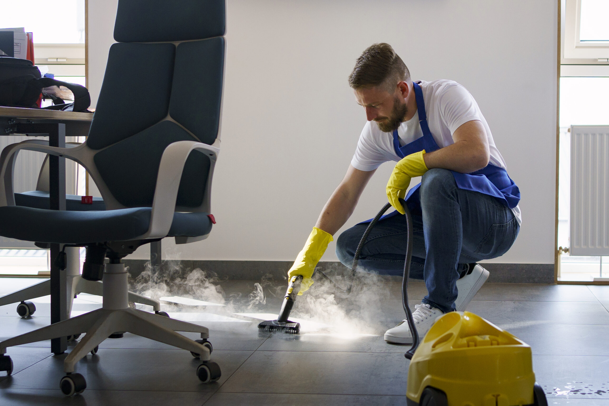 professional cleaning service person using steam cleaner office scaled